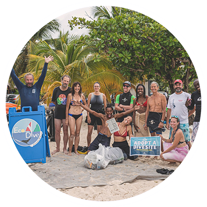 A group of scuba divers posing for a photo on the beach in Grenada. A group of scuba divers posing for a photo on the beach in Grenada.